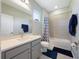 Clean bathroom with gray vanity, tub, and shower at 30053 Island Club Dr, Tavares, FL 32778