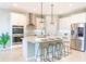 Modern kitchen boasts white cabinets, stainless steel appliances, and a large island with seating at 30053 Island Club Dr, Tavares, FL 32778