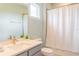 Modern bathroom with gray vanity and white shower curtain at 30053 Island Club Dr, Tavares, FL 32778