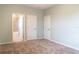 Bedroom with carpet, doors to bathroom and other rooms at 30053 Island Club Dr, Tavares, FL 32778