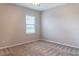 Well-lit bedroom featuring neutral walls, carpet flooring and a window at 30053 Island Club Dr, Tavares, FL 32778