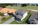 Two-story home with gray roof and stone accents, near golf course at 30053 Island Club Dr, Tavares, FL 32778