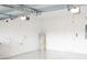 Garage with white walls, new water heater, and epoxy flooring at 30053 Island Club Dr, Tavares, FL 32778