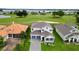 Two-story house with gray roof and blue garage doors, situated on a golf course at 30053 Island Club Dr, Tavares, FL 32778