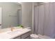 Clean bathroom with gray vanity, white sink, and shower at 30053 Island Club Dr, Tavares, FL 32778