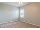 Spacious bedroom with neutral walls and carpet, featuring a ceiling fan and window at 30053 Island Club Dr, Tavares, FL 32778
