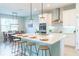 Modern kitchen with white cabinets, stainless steel appliances & breakfast bar at 30053 Island Club Dr, Tavares, FL 32778