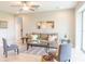 Bright living room features a comfy sofa, accent chairs, and a large glass door leading outside at 30053 Island Club Dr, Tavares, FL 32778