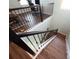 Elegant staircase with dark wood and metal railings at 30053 Island Club Dr, Tavares, FL 32778