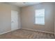 Simple bedroom with carpeted floor, neutral walls, and window blinds at 30053 Island Club Dr, Tavares, FL 32778