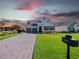 Two-story house with gray double doors and stone facade at 30053 Island Club Dr, Tavares, FL 32778