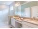Spa-like bathroom with double vanity, large mirror, and a walk-in shower at 30053 Island Club Dr, Tavares, FL 32778