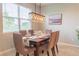 Elegant dining room features a wooden table with six chairs and a large window at 30053 Island Club Dr, Tavares, FL 32778