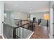 Spacious loft area with hardwood floors and a modern railing at 30053 Island Club Dr, Tavares, FL 32778