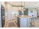 Modern kitchen with white cabinets, stainless steel appliances & island at 30053 Island Club Dr, Tavares, FL 32778