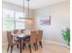 Bright dining room with a wooden table and six chairs, plus a window at 30053 Island Club Dr, Tavares, FL 32778