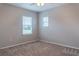 Bright bedroom with two windows, ceiling fan and neutral wall paint at 30053 Island Club Dr, Tavares, FL 32778