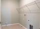 Functional laundry room with wire shelving at 30053 Island Club Dr, Tavares, FL 32778