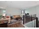 Open loft featuring two seating areas and hardwood flooring at 30053 Island Club Dr, Tavares, FL 32778