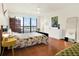 Bright bedroom with floral bedding, large window, and ample closet space at 530 E Central Blvd # 802, Orlando, FL 32801