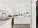 Modern kitchen with white cabinets and view into living room at 530 E Central Blvd # 802, Orlando, FL 32801