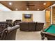 Relaxing game room with a pool table, comfortable seating, and bookshelves at 530 E Central Blvd # 802, Orlando, FL 32801