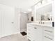 Modern bathroom with a white vanity, large mirror and a walk-in shower at 530 E Central Blvd # 802, Orlando, FL 32801