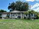 House exterior with a lawn, palm trees, and a two-car garage at 809 Florida Pkwy, Kissimmee, FL 34743