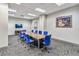 Large conference room with long table and blue chairs at 150 E Robinson St # 1709, Orlando, FL 32801