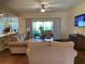 Spacious living room with hardwood floors and access to backyard at 4739 Spring Grove Ln, Leesburg, Fl, FL 34748