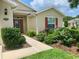 Landscaped front yard with a walkway leading to the house entrance at 4739 Spring Grove Ln, Leesburg, Fl, FL 34748