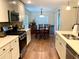 Open concept kitchen with stainless steel appliances and hardwood floors at 4739 Spring Grove Ln, Leesburg, Fl, FL 34748