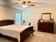 Spacious bedroom with a king-size bed, dresser, and ceiling fan at 4739 Spring Grove Ln, Leesburg, Fl, FL 34748