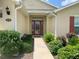 Front door entry with mature shrubs and walkway at 4739 Spring Grove Ln, Leesburg, Fl, FL 34748