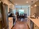 Open concept kitchen with stainless steel appliances and hardwood floors at 4739 Spring Grove Ln, Leesburg, Fl, FL 34748