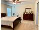 Spacious bedroom with a king-size bed, dresser, and ceiling fan at 4739 Spring Grove Ln, Leesburg, Fl, FL 34748