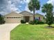 Exterior view of a single-Gathering house with a two-car garage and landscaping at 4739 Spring Grove Ln, Leesburg, Fl, FL 34748