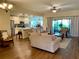 Open living room and kitchen area with hardwood flooring at 4739 Spring Grove Ln, Leesburg, Fl, FL 34748