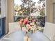 Relaxing screened balcony with a table, chairs and flower arrangement at 5300 S Atlantic Ave # 8-207, New Smyrna Beach, FL 32169