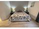 Bright bedroom with a queen-size bed and wood-look flooring at 5300 S Atlantic Ave # 8-207, New Smyrna Beach, FL 32169