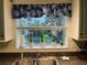 Kitchen features a sink, window with view and tiled backsplash at 5300 S Atlantic Ave # 8-207, New Smyrna Beach, FL 32169