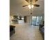 Open concept living room, kitchen area with marble flooring and access to balcony at 5300 S Atlantic Ave # 8-207, New Smyrna Beach, FL 32169