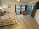 Spacious main bedroom with a king-size bed and access to a private balcony at 5300 S Atlantic Ave # 8-207, New Smyrna Beach, FL 32169