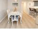 Elegant dining room featuring a white table and six chairs at 5300 S Atlantic Ave # 8-207, New Smyrna Beach, FL 32169