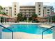 Inviting community pool with surrounding lounge chairs at 5300 S Atlantic Ave # 8-207, New Smyrna Beach, FL 32169