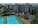Aerial view of condo complex with tennis and shuffleboard courts at 5300 S Atlantic Ave # 8-207, New Smyrna Beach, FL 32169