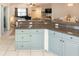 Kitchen features granite countertops and light blue cabinets at 5300 S Atlantic Ave # 8-207, New Smyrna Beach, FL 32169