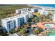 Aerial view of condo complex near the beach with tennis courts at 5300 S Atlantic Ave # 8-207, New Smyrna Beach, FL 32169