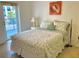 Bedroom with queen-size bed and access to a balcony at 5300 S Atlantic Ave # 8-207, New Smyrna Beach, FL 32169
