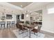 Bright dining room features a wood table with leather chairs, and a modern chandelier at 1967 Spring Shower Cir, Kissimmee, FL 34744